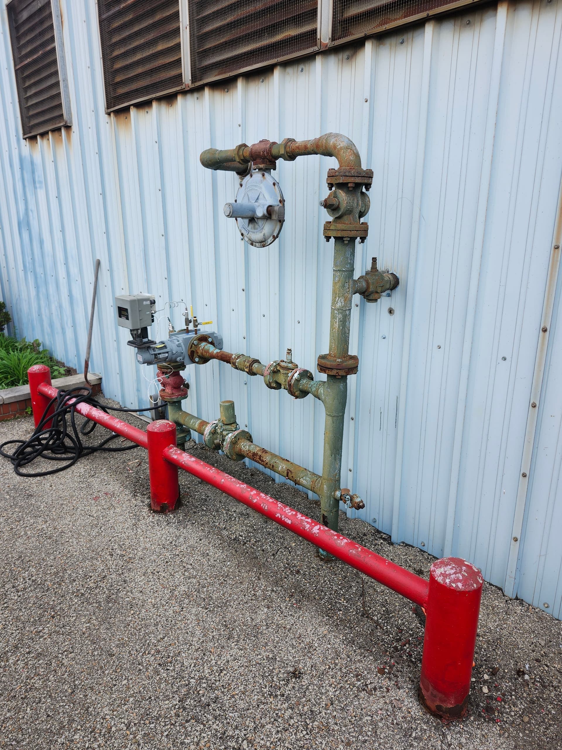 Fresh Coating on Industrial Gas Piping and Safety Bollards image